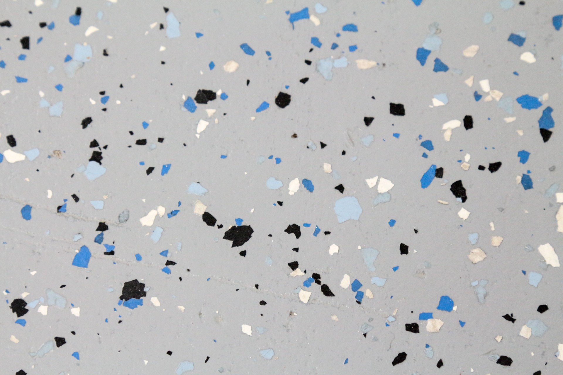 Close up of an epoxy garage floor with multi-colored flecks